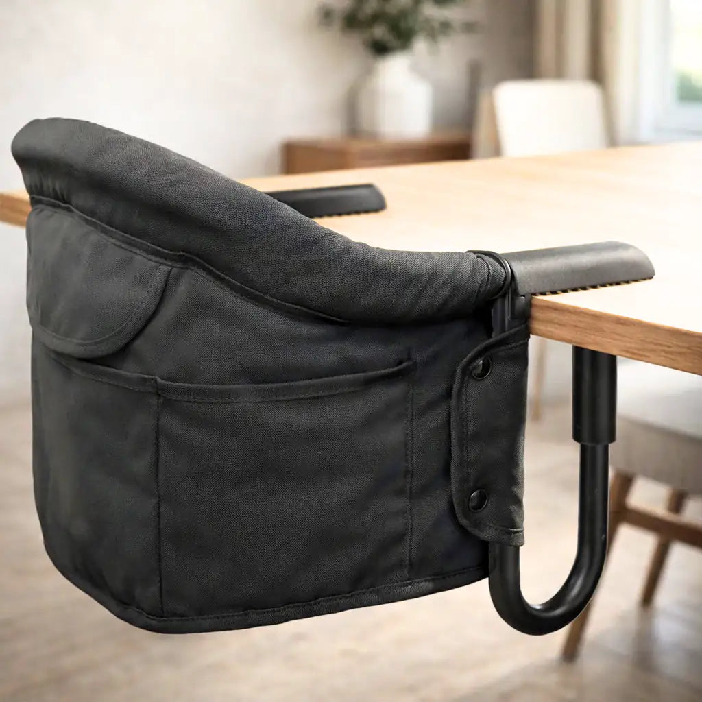 Black clip-on high chair attached to a table